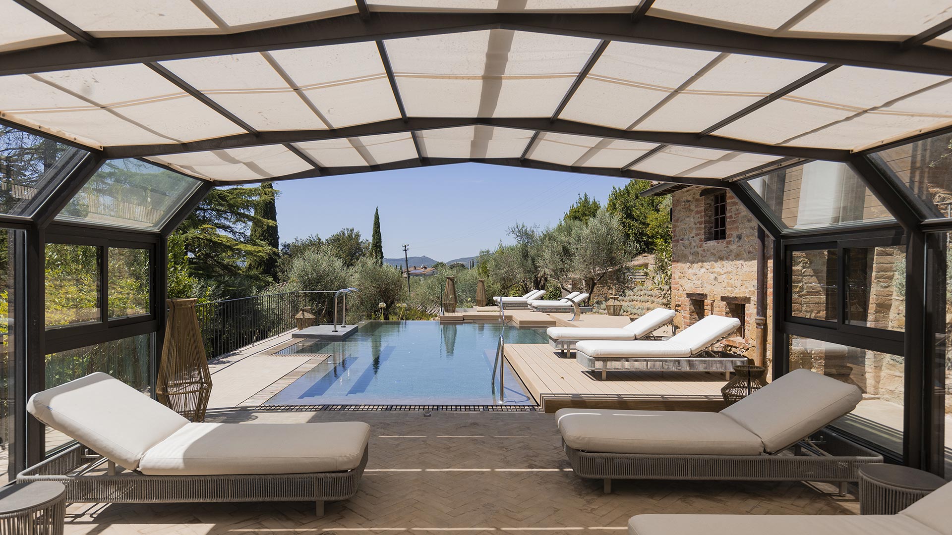 Area relax e piscina esterna del luxury resort Borgo dei Conti